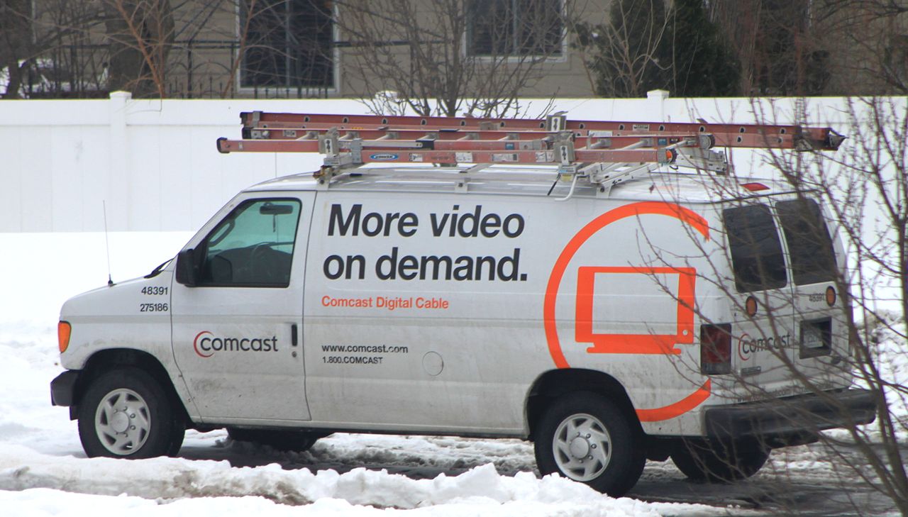 Take van. Comcast Truck.